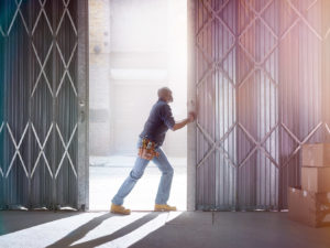 Image of a man opening the door of a warehouse