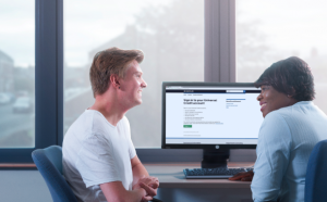 Image of a work coach helping someone claim Universal Credit